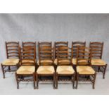 A set of ten antique style oak ladderback dining chairs on stretchered turned supports. H.100cm
