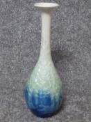 A Chinese crystalline glaze long necked vase with a blue to green to white gradient. H28.5cm.