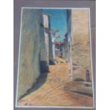 A framed and glazed pastel depicting a street in the south of France. By Antoine Ceyssens. (1900-