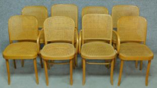 A set of eight contemporary bentwood dining chairs with caned backs and seats, to include two