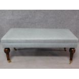 An Edwardian style footstool upholstered in pale grey linen on turned tapering supports. H.47 W.