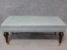 An Edwardian style footstool upholstered in pale grey linen on turned tapering supports. H.47 W.