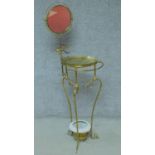 An Edwardian brass washstand with swing mirror on scrolling frame and feet. H.141cm
