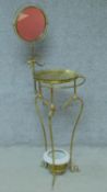 An Edwardian brass washstand with swing mirror on scrolling frame and feet. H.141cm
