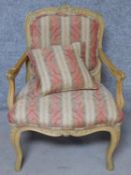 A Louis XV style carved beech fauteuil armchair with matching pillow on cabriole supports. H.91cm