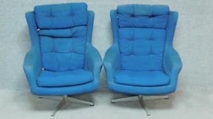 A pair of 1970's vintage easy armchairs upholstered in royal blue calico. H.96cm