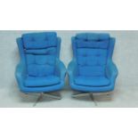 A pair of 1970's vintage easy armchairs upholstered in royal blue calico. H.96cm