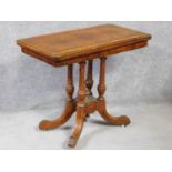 A Victorian burr walnut and satinwood inlaid card table with foldover top on quadruped column