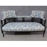 A late Victorian ebonised carved back double chair end sofa on cabriole supports. H.80 W.150 D.70cm
