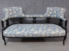 A late Victorian ebonised carved back double chair end sofa on cabriole supports. H.80 W.150 D.70cm
