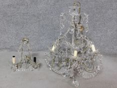 A vintage crystal glass chandelier with cut petal decoration together with a similar lamp. H.62cm