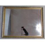 A gilt wall mirror with scrolling floral decorated frame. 112x87cm