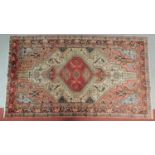 A Qashqai style rug with central pendant medallion set on a rouge field surrounded by repeating