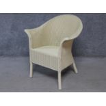 A vintage style Lloyd Loom conservatory armchair with makers label. H.82cm