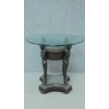 An Anglo African rattan glass top coffee table on figural supports. H.68 L.72 W.72cm