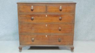 A Georgian mahogany chest of two short over three long drawers fitted with ivory escutcheons on