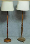 A mid 20th century oak standard lamp and another similar. H.180cm