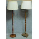 A mid 20th century oak standard lamp and another similar. H.180cm