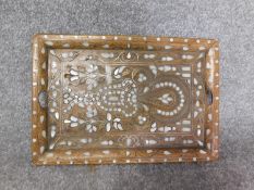 An antique Indian teak mother of pearl inlaid abstract design tray with brass foliate detailing