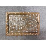 An antique Indian teak mother of pearl inlaid abstract design tray with brass foliate detailing