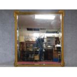 A large 19th century gilt and gesso framed overmantel mirror fitted with bevelled plate. 183x165cm
