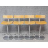 A set of four metal framed high stools with laminated beech bar backs and seats. H.86cm