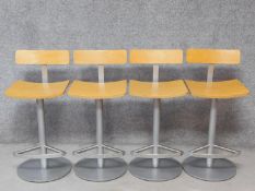 A set of four metal framed high stools with laminated beech bar backs and seats. H.86cm