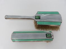 Two Art Deco enamel, silver and carved jade brushes by Deakin & Francis. Engine turned decoration
