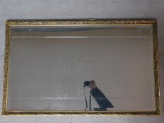 A gilt framed wall mirror with etched and bevelled plate. 92x57cm