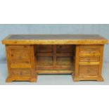 An Eastern teak pedestal desk with an arrangement of five drawers. H.78 W.179 D.59cm (from treated