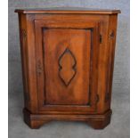 A Continental fruitwood corner cupboard with carved panel door on bracket feet. H.90x70x50cm