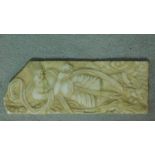 An antique Asian carved alabaster plaque of a lounging deity. 35x13cm