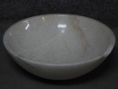 A carved circular polished white marble wash basin. H.15 W.43 D.43cm