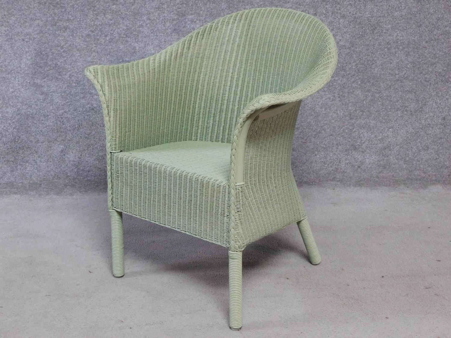 A vintage style willow green lacquered Lloyd Loom conservatory armchair with makers label. H.81cm