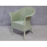 A vintage style willow green lacquered Lloyd Loom conservatory armchair with makers label. H.81cm