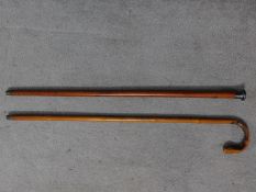 A Chinese bamboo carved walking stick together with an Edwardian gentleman's cane with a white metal