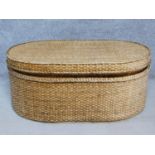 A wicker ottoman fitted with lift out tray by Oka. H.46 W.110 D.72cm