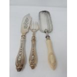 A set of antique repousse silver plated fish servers and a silver plated crumb scoop with carved