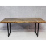 A 20th century pine planked top refectory table on metal supports. H.78 W.190 D.87cm