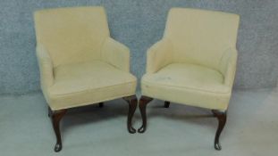 A pair of Georgian style cream upholstered armchairs on cabriole supports. H.82cm