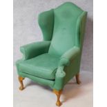 A Georgian style wing back armchair on cabriole supports. H.120cm