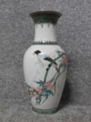 A Liling Chinese handpainted porcelain vase with a bird sitting in a blossom tree. Three Chinese