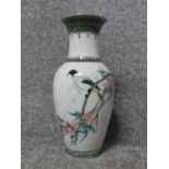 A Liling Chinese handpainted porcelain vase with a bird sitting in a blossom tree. Three Chinese