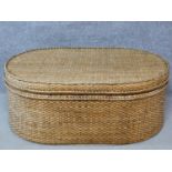 A wicker ottoman fitted with lift out tray by Oka. H.45 W.111 D.72cm