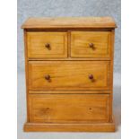 A Victorian oak apprentice piece chest of drawers with two short over two long drawers on plinth