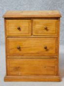 A Victorian oak apprentice piece chest of drawers with two short over two long drawers on plinth