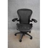 A contemporary Herman Miller Aeron ergonomic design office chair with reclining, swivelling and up