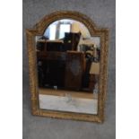 An antique gilt framed domed top easel mirror with original plate. H.63x46cm