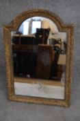 An antique gilt framed domed top easel mirror with original plate. H.63x46cm