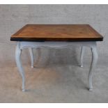 A distressed painted French style draw leaf dining table with oak parquetry top H.70x102x75cm (ext.